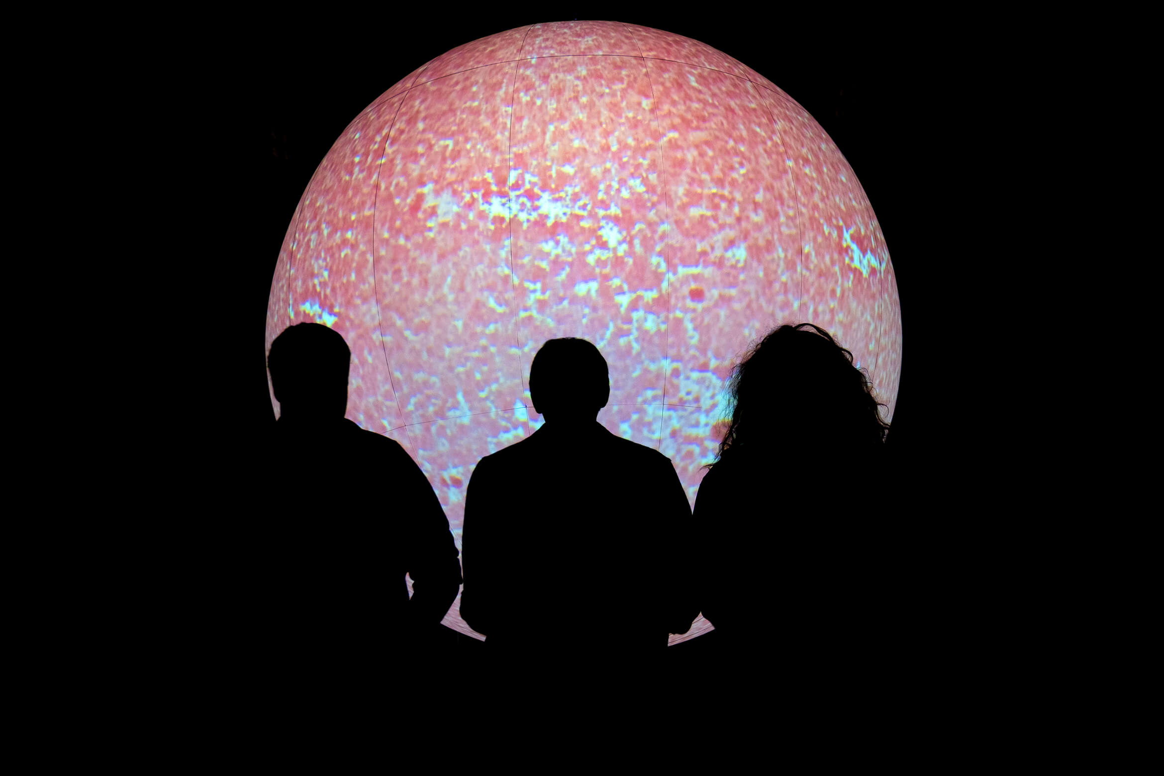 Three people looking at SUN during a pink phase